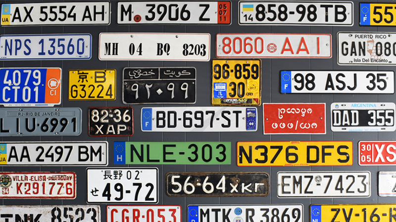 Multiple Past and Present License Plates from Around the World on a Board